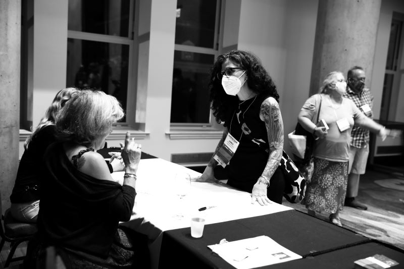 Writer aimee christian talking with marion winik at signing