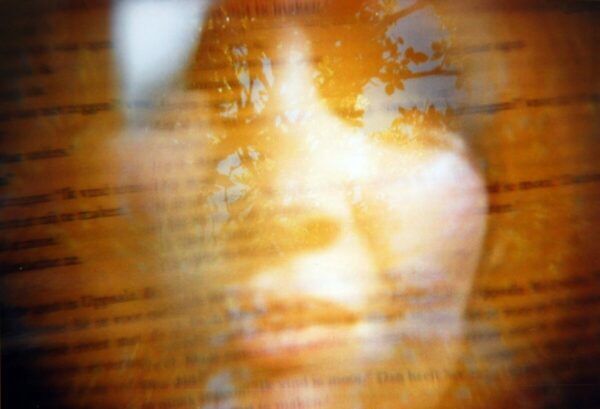Womans face with tree and book reflection