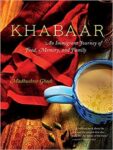 Cup of chai is seen and vivid red cloth is seen on book cover of Khabaar