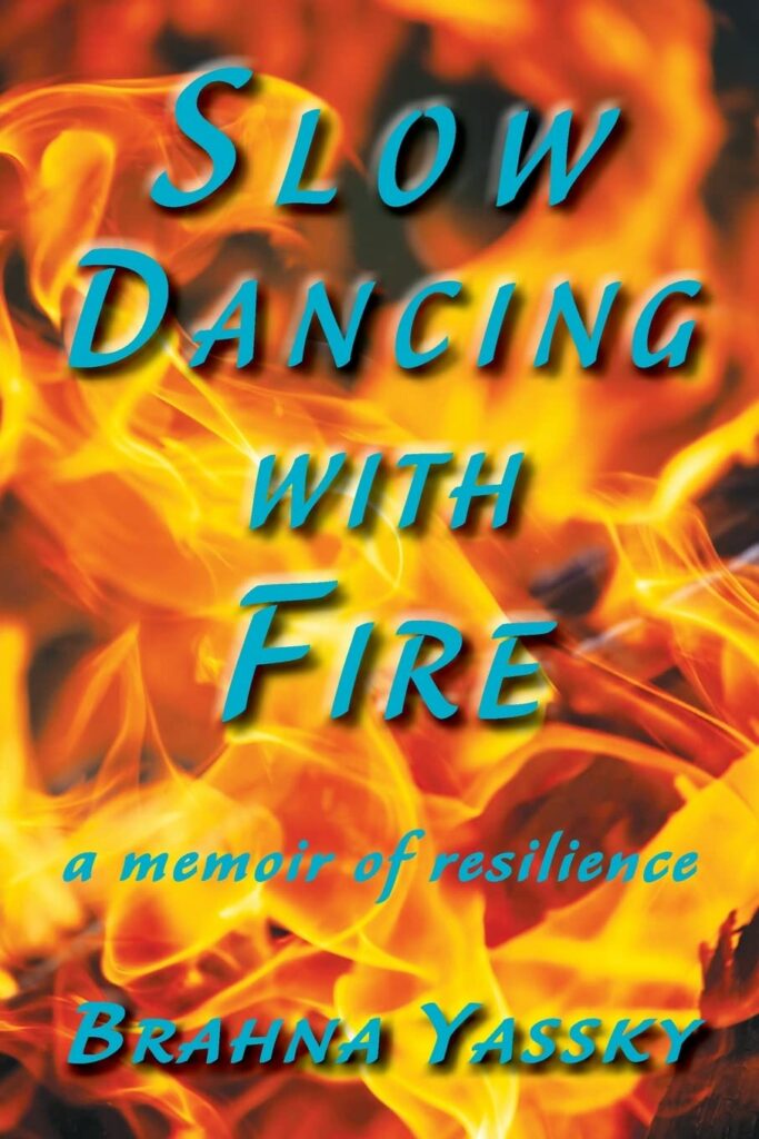 The book title Slow Dancing With Fire is in blue letters against a background of yellow flames