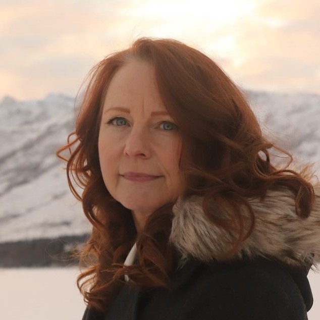 Headshot of author Candace Cahill against the Alaskan mountains