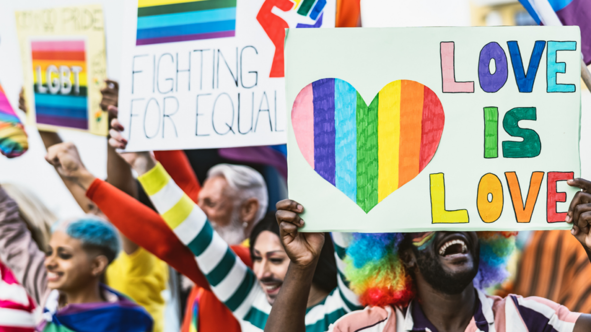 Colorful love is love and other signs at a equality demonstration