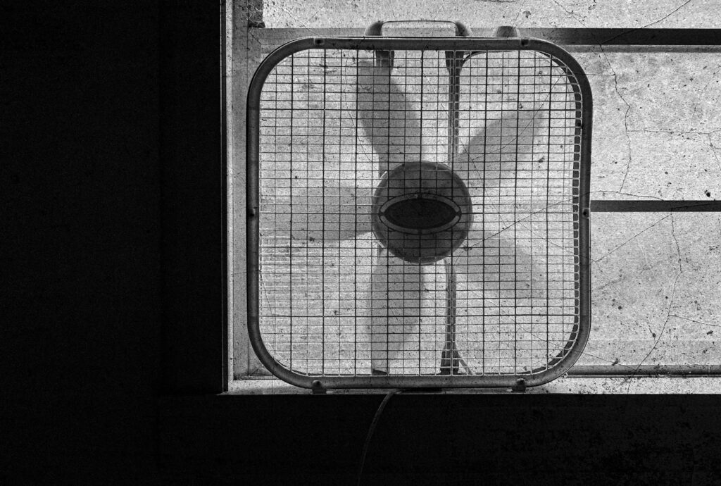 Box fan in old window
