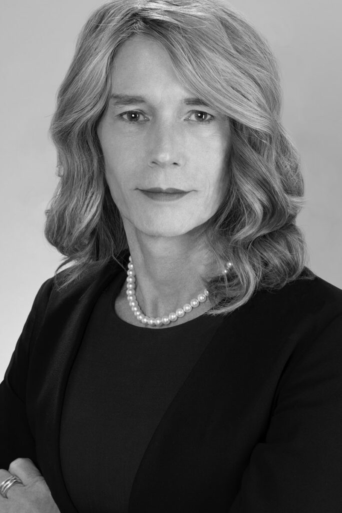 Black and white photo of author Maeve DuVally, a white trans woman. 