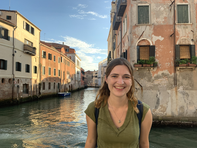 Olivia Flaherty-Lovy with canal and historic buildings in background