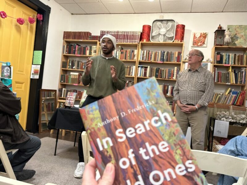 interior of book store with owner introducing an author, anthony d fredericks author of in search of the old ones