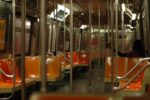 A subway train with orange seats