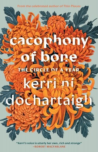 The book title Cacophony of Bone is seen in white letters against the background of a bright orange chrysanthemum