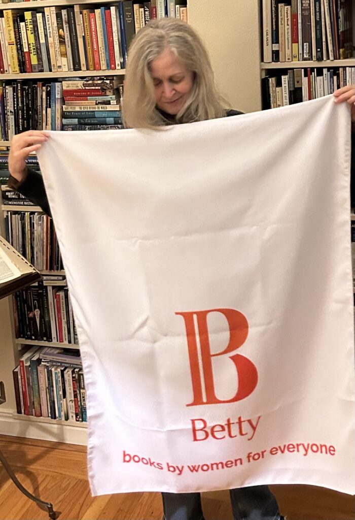 Peg Pursell Holding a Banner for Betty Books