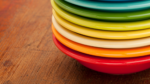 A stack of colorful plates in rainbow order