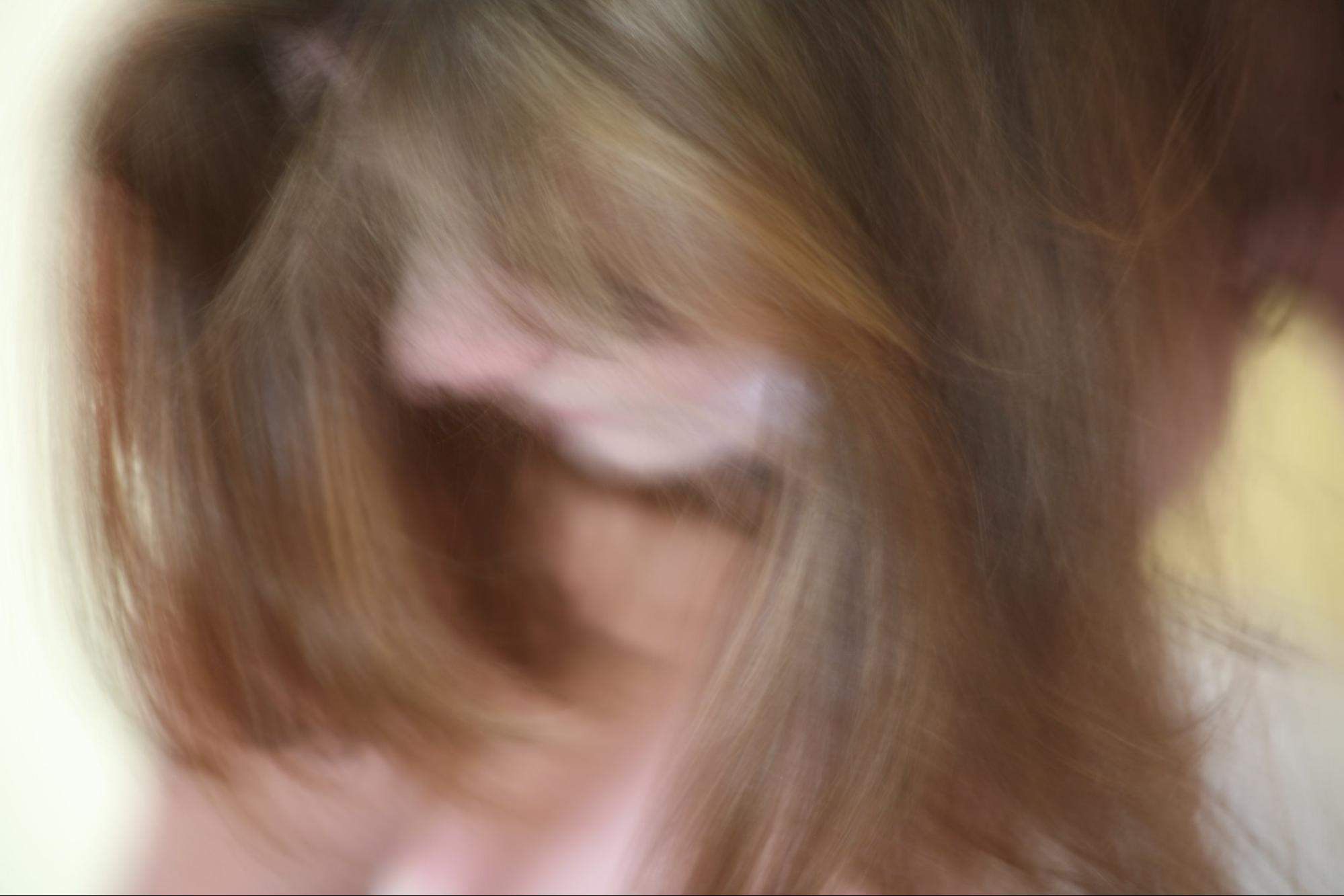 close-up and blurry image of long hair