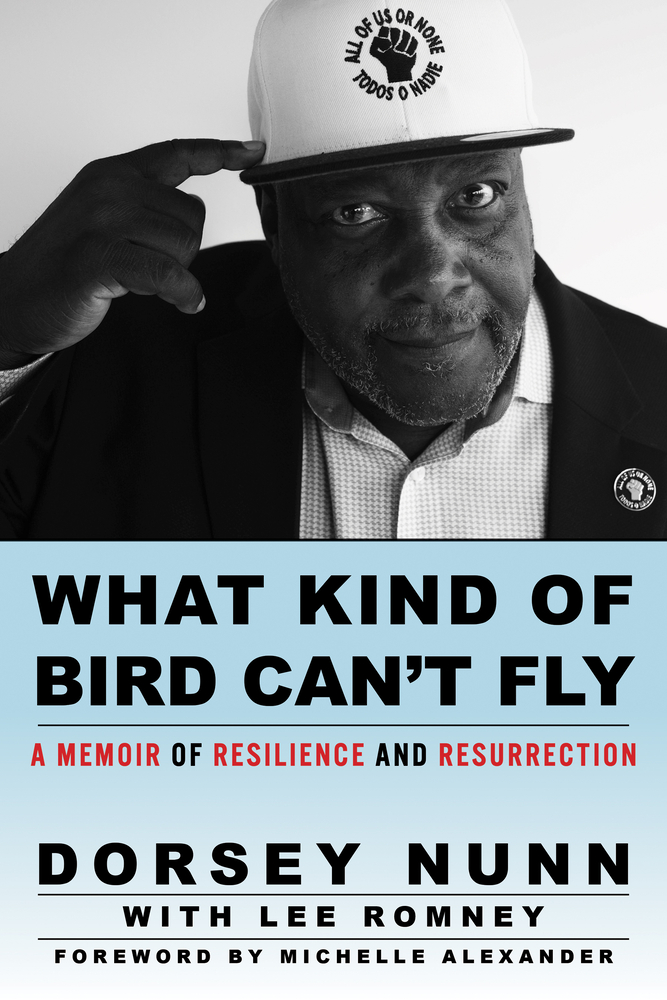 cover of Dorsey Nunn memoir, What Kind of Bird Can't Fly: A Memoir of Resilience and Resurrection; author pointing at hat that says "All of Us or None"