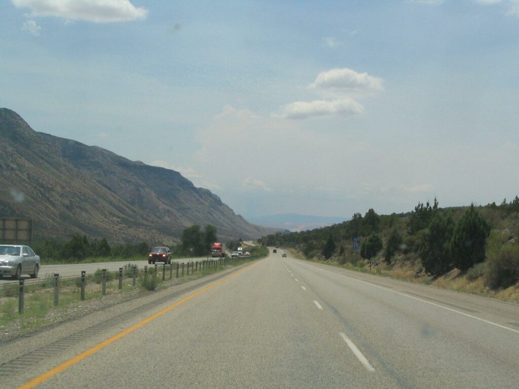 Long shot of a road going out to the distance; mountains on the right